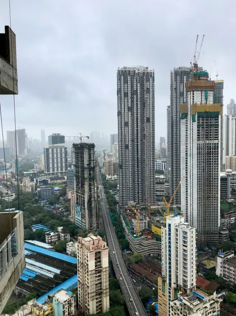 High-rise buildings along a busy Mumbai road